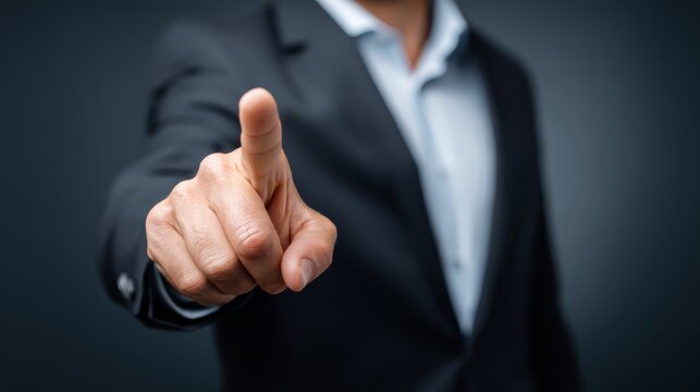 Businessman pointing forward gesture in dark suit