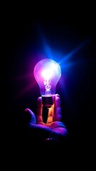 Hand Holding a Light Bulb Radiating with Colorful Energy and Innovation