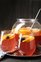 Fruity punch on black table, closeup. Refreshing drink