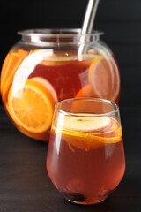Fruity punch on black wooden table, closeup. Refreshing drink