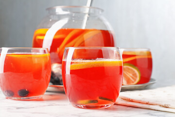 Fruity punch on white marble table, closeup. Refreshing drink