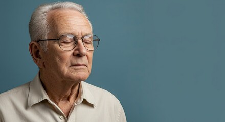 Calm senior man meditating with glasses, his calm face shows deep wisdom