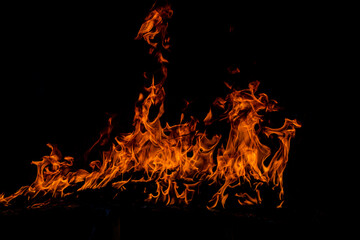 Texture of fire on a black background. Abstract fire flame background, large burning fire.
