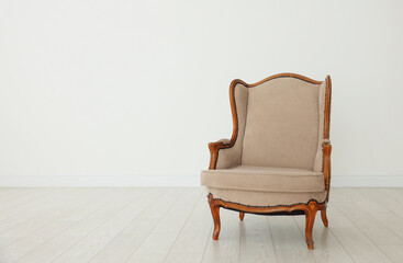 Stylish armchair near white wall indoors, space for text