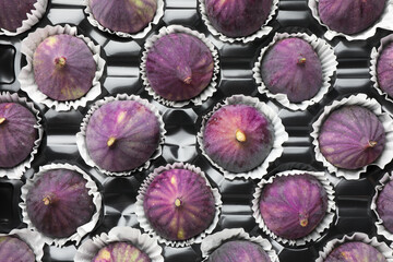 Fresh ripe figs in plastic container, top view