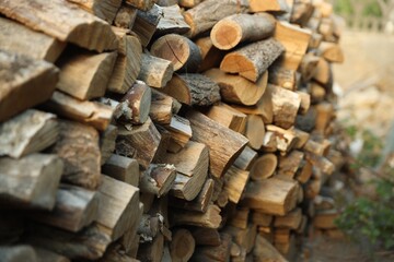 Pile of cut firewood outdoors, closeup view