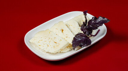 Sliced white cheese on plate