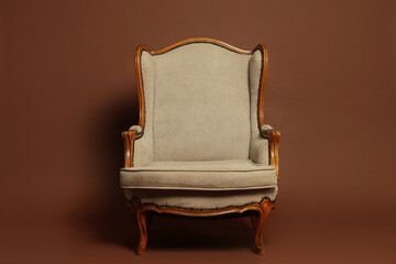Stylish armchair on brown background. Used stuff