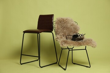 Bar stool, chair and shoes on olive background. Used stuff
