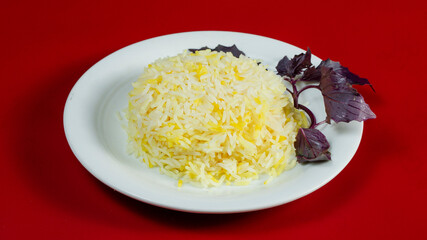 Rice on plate isolated on red