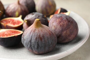 Whole and cut figs on table, closeup