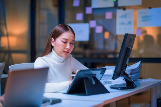 Asian programmer leverages generative AI assistance for deep learning and data driven analysis, optimizing a scalable, cloud native workflow in their modern, hyper automated smart office