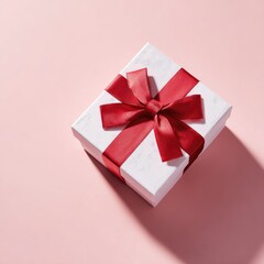 Fototapeta premium Elegant White Gift Box with Red Ribbon on Pink Background.