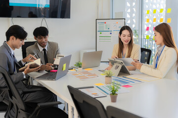 Marketing concept with laptop in office, Asian business group teamwork brainstorming meeting and discussing strategy, financial analysis, successful plan.