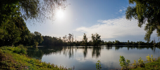 Scenic lake landscape with sun and trees Germany, Mering, 17 September 2025