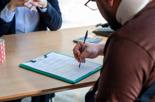 Man signing a document paper, insurance, legal contract or lawyer consulting. Disability people, attorney or advocate in negotiation, policy advice or accident report closeup