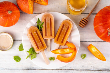 Sweet tasty pumpkin and honey popsicles ice cream. Frozen sorbet gelato on sticks, made with...
