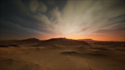 Vast desert stretches under a vibrant sky as the sun rises, casting enchanting light across the rugged terrain. Soft clouds and golden hues create a mesmerizing atmosphere at dawn.