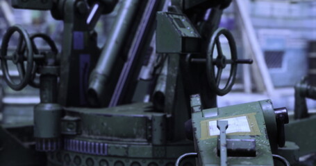 Fototapeta premium A large industrial machine is actively working in a manufacturing facility. It demonstrates complex mechanisms and precision engineering. Surrounding materials and equipment are evident.