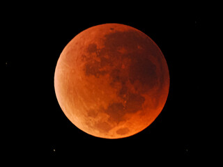A captivating shot of a blood moon during a total lunar eclipse. Its reddish hue, caused by light filtering through Earth's atmosphere, stands out against the dark sky, 17 September 2025 Indonesia