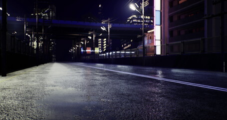 Under the night sky, a deserted urban road glimmers as bright lights bounce off the wet surface. Tall buildings loom, creating a vibrant yet serene atmosphere in the bustling city.