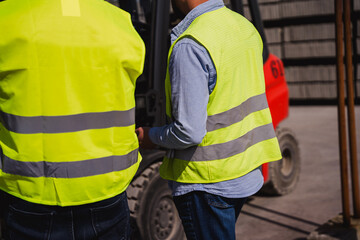 Engineers from back overseeing construction site progress. Control safety on contruction site.
