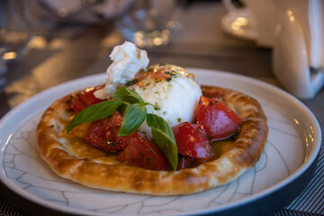 Delicious mozzarella dish with fresh tomatoes and basil at a stylish restaurant
