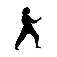 A striking silhouette of a woman in a karate stance, showcasing a powerful and focused pose.