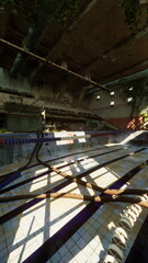 Fototapeta premium An old, emptied swimming pool devoid of any individuals, showcasing a desolate scene.