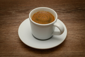 Cup of Turkish coffee on wooden table closeup