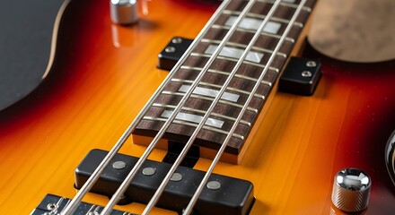Close-up of a bass guitars fretboard and pickups, showcasing its sunburst finish and intricate details.