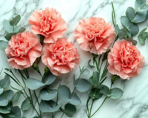 Soft pink carnations and eucalyptus leaves arranged on a marble surface