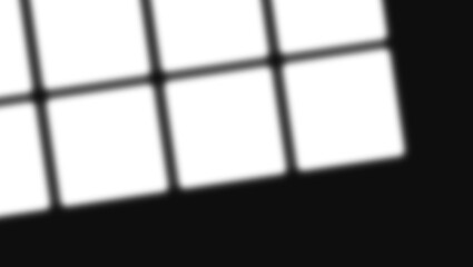 Abstract geometric shadow pattern from window panes on a dark surface