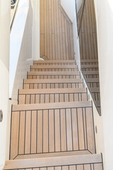 Teak stairs ladder on luxury yacht. Elements of yacht construction. Superyacht concept.