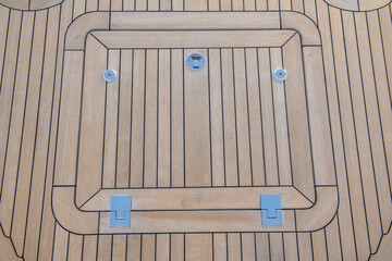 Teak hatch cover on deck luxury yacht. Elements of yacht construction. Superyacht concept.