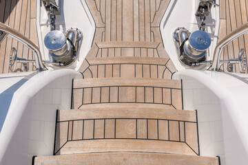 Teak stairs ladder on luxury yacht. Elements of yacht construction. Superyacht concept.