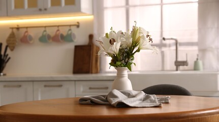 Vase with beautiful flowers on dining table in kitchen