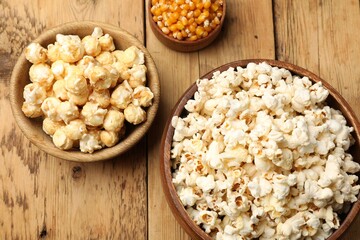 Tasty popcorn and corn kernels on wooden table, flat lay