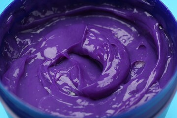 Care cosmetic product for blonde hair in jar on light blue background, closeup