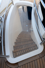 Teak stairs ladder on luxury yacht. Elements of yacht construction. Superyacht concept.