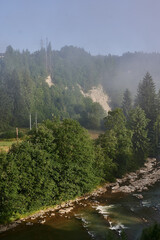 fog in the mountains houses at altitude green forest summer