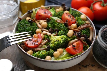 Delicious salad with shimeji mushrooms served on table, closeup