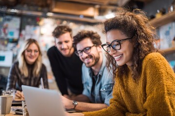 Diverse Team Collaborating on Laptop in Modern Office