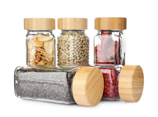 Different aromatic spices in glass jars isolated on white