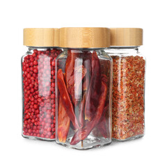 Different aromatic spices in glass jars isolated on white