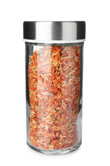 Dried carrot flakes in spice jar isolated on white