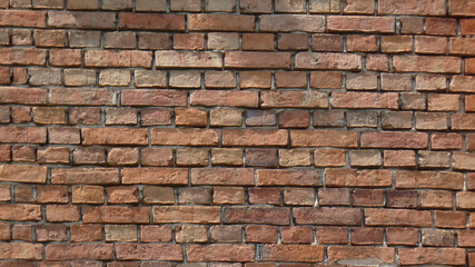 Brick wall with a rustic appearance showcasing various shades and textures in natural light