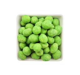 Wasabi coated peanuts in bowl isolated on white, top view