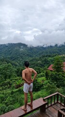Naklejka premium Shirtless man looking at mountain view on a transparent background