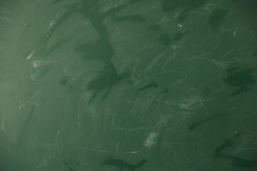 Blank green chalkboard as background, closeup view